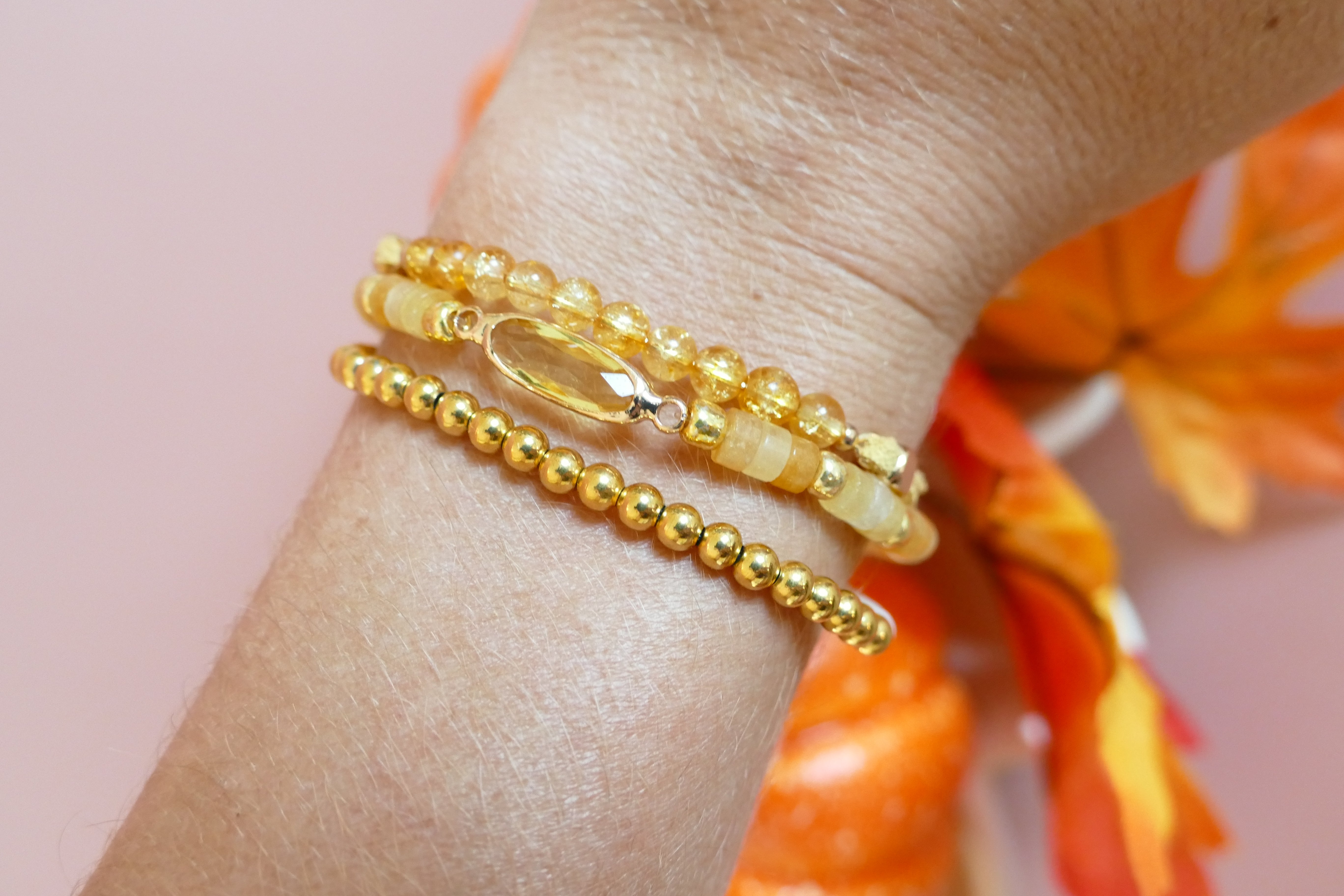 Yellow bracelets with pumpkin background.
